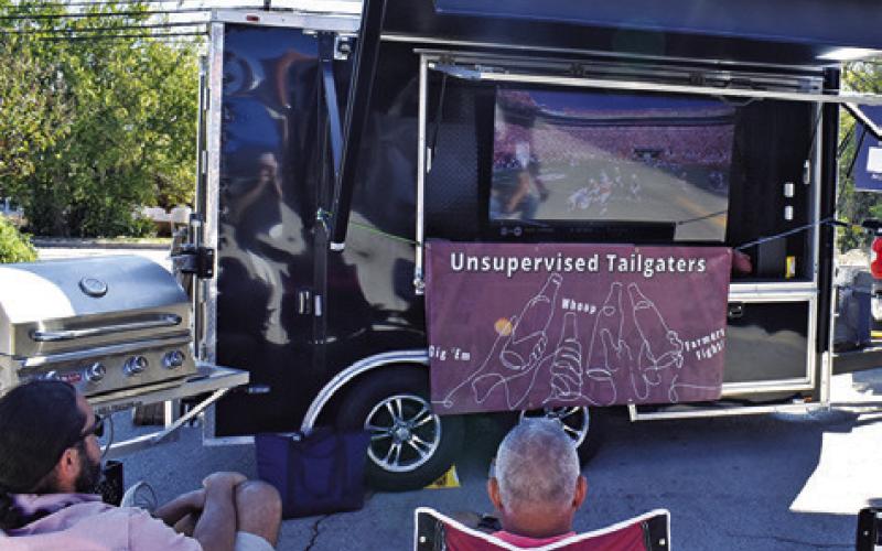 TAILGATERS ENJOY THIS spot on Saturday during the “Toasting at the ‘Well” beer and wine walk in downtown Caldwell.