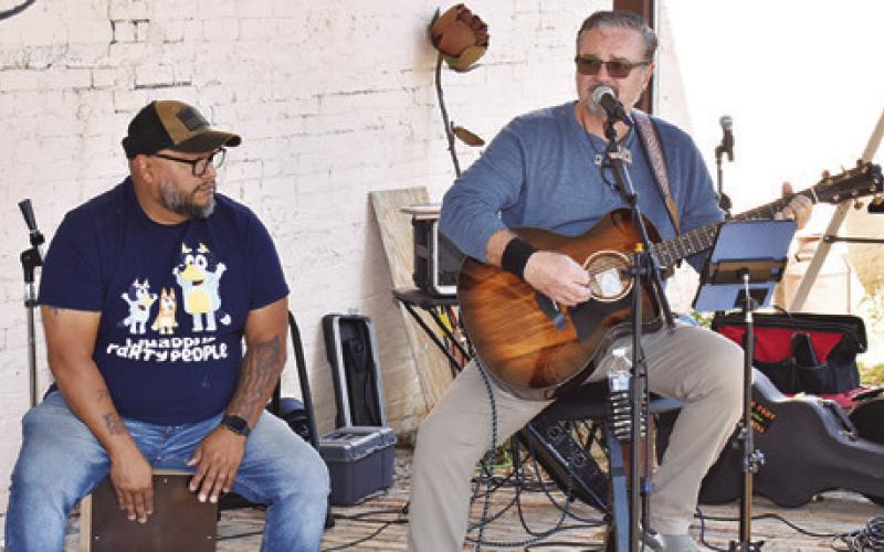 SY NICHOLS AND JUAN Fraustro perform at Lissa’s on Saturday during the “Toasting at the ‘Well” beer and wine walk in Caldwell.