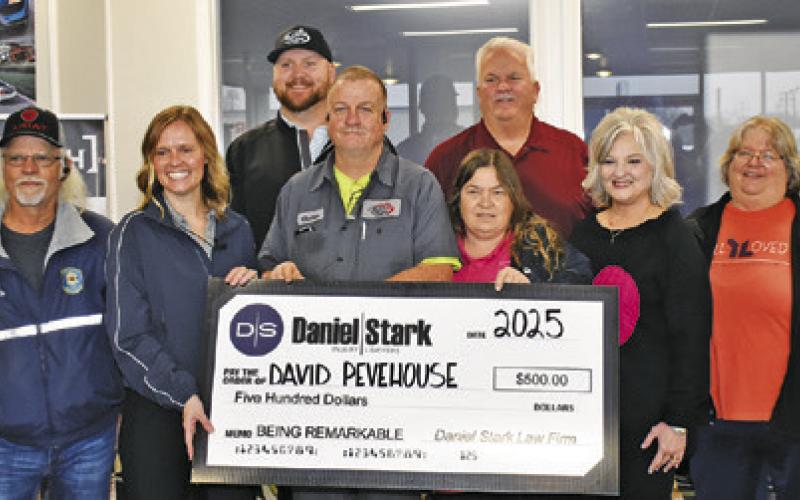 DAVID PEVEHOUSE IS presented this check for $500 from Daniel/ Stark Law Firm in their Being Remarkable program