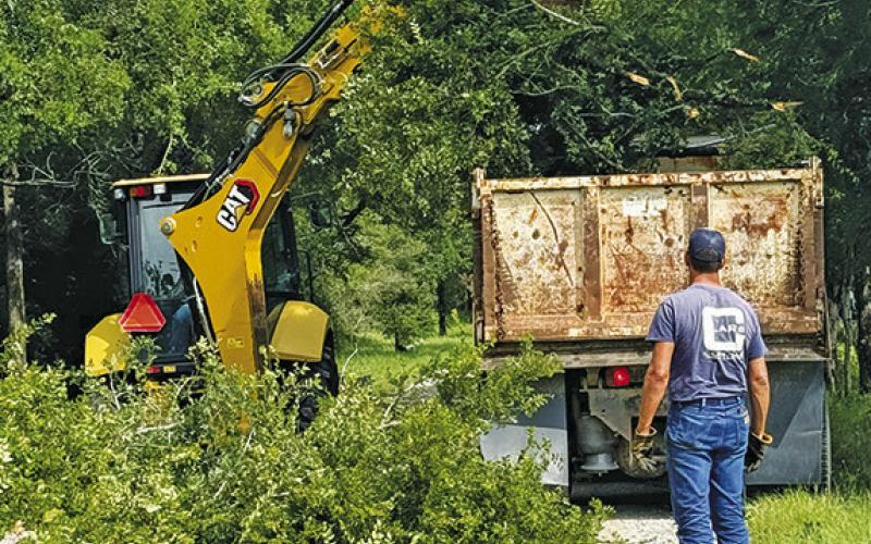 TREES AND limbs are removed by Burleson County Precinct 4 crews off County Road 463.