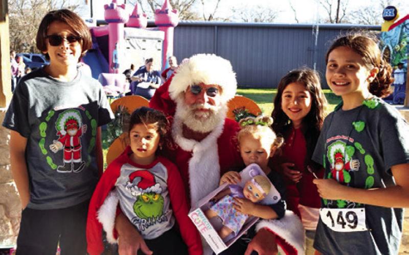 SANTA VISITS WITH CHILDREN at last year’s Santaville event in Somerville. Photo courtesy of Allyson Hargrove