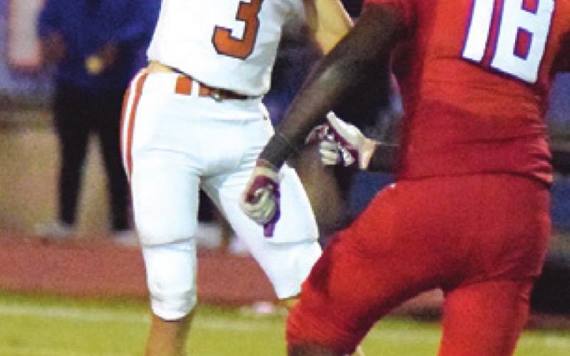 CALDWELL QUARTERBACK Ryan Shupak is pressured by Brookshire Royal defensive end Kendrian Vinson during the Hornet’s loss last Friday. -- Tribune photo by Denise Squier