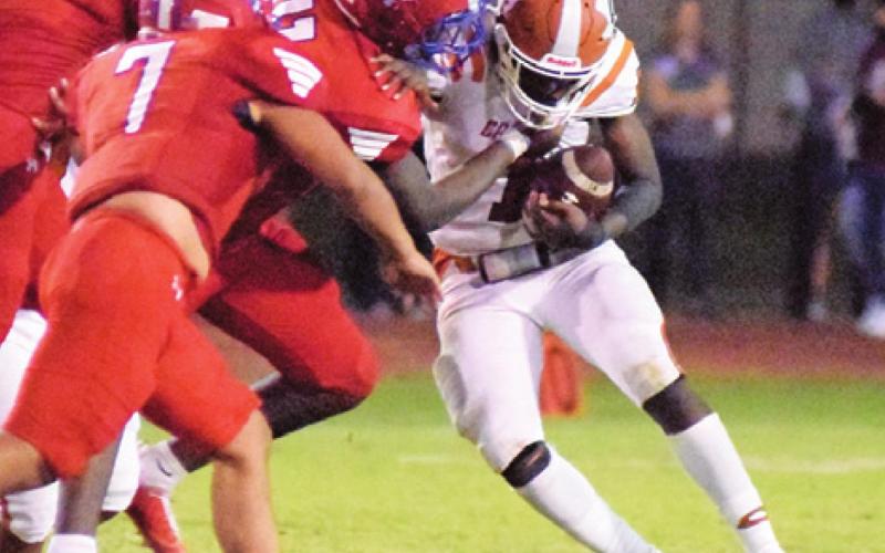 THE ROYAL FALCON defensive frontline tries to tackle Caldwell runningback Jamar Hewitt during last Friday night’s game in Brookshire. -- Tribune photo by Denise Squier