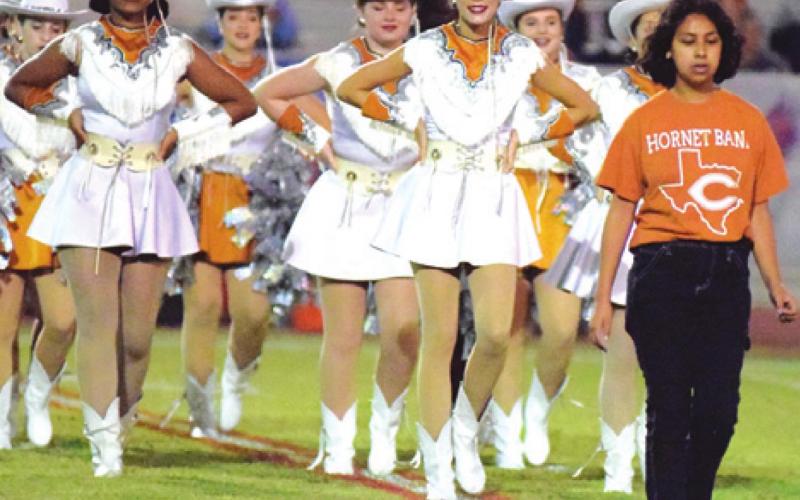 CALDWELL DRUM MAJOR Cierra Zamora leads the Honeybees onto the field during Friday night’s football game at Brookshire Royal.