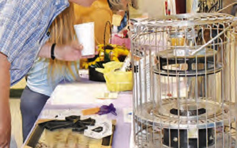 THESE AUCTION items are examined on Saturday at the fundraiser for New Tabor Brethren Church’s building reconstruction.