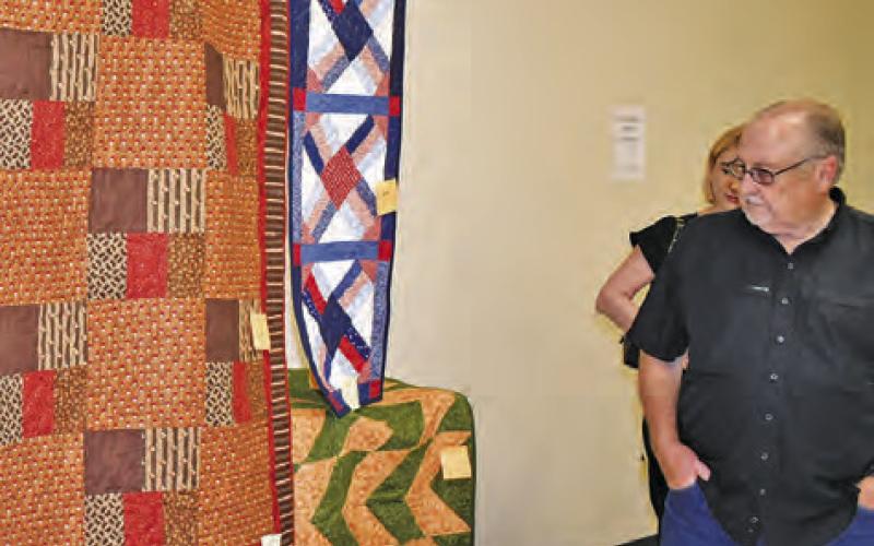 THESE QUILTS ARE admired by passersby at the New Tabor Brethren Church fundraiser on Saturday at the Expo Center in Caldwell.