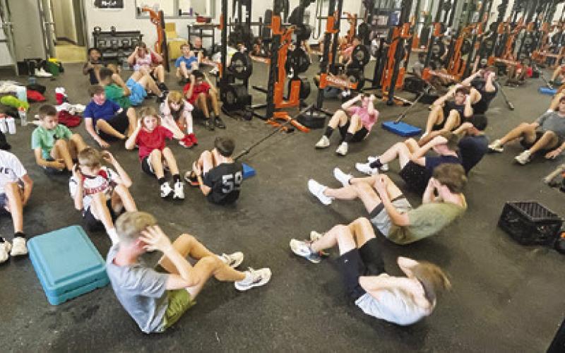 WHILE MANY STUDENTS LOUNGE AROUND the house in the summer, Caldwell ISD students are doing sit-ups during Strength and Conditioning Camp at Caldwell High School.