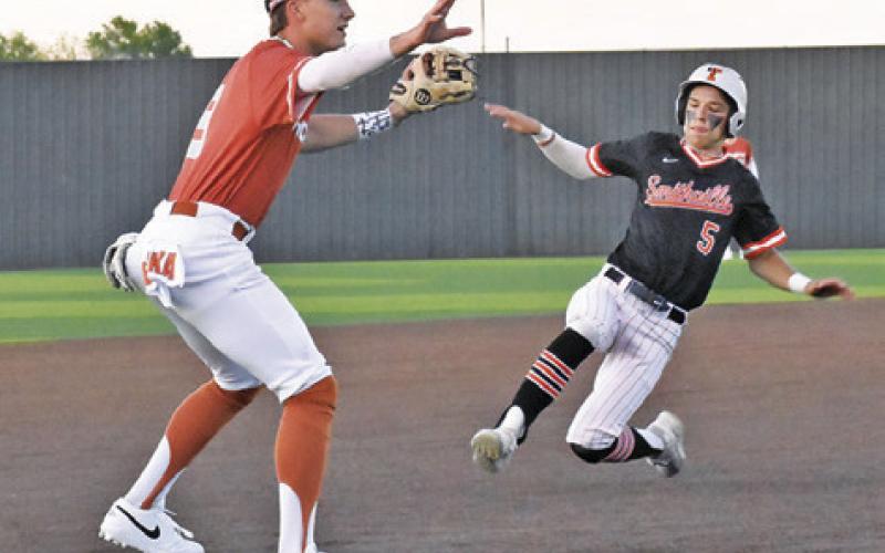 COY BECKA GETS ready to tag out this Smithville base runner in last Friday’s game. -- Tribune photo by Roy Sanders