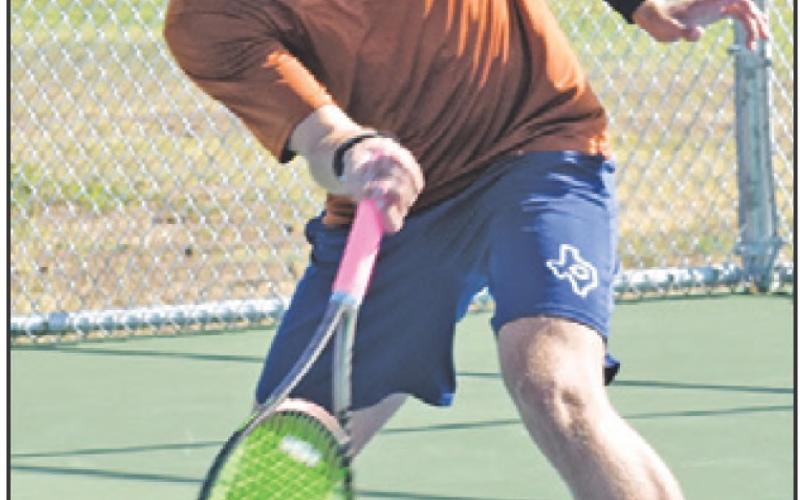 WAYLON CHAPMAN returns serve during the Caldwell-Cameron Yoe match last Thursday. — Tribune photo by Roy Sanders