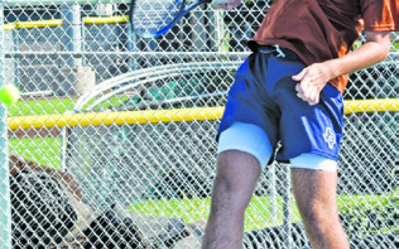 CALDWELL’S CONNOR HUGHSON attempts to return the ball during the Hornets’ first ever home team tennis match last Thursday.