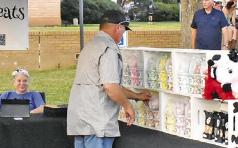 VENDORS LIKE THESE drew visitors on Saturday night in the town square while T. Cole and the Austin Party Band performed.