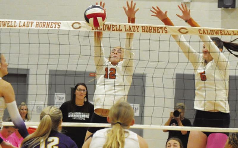 CALDWELL’S ABBY VOGLER blocks a hit from a La Grange player during the Caldwell-La Grange match on Friday. Tribune photo by Denise Squier
