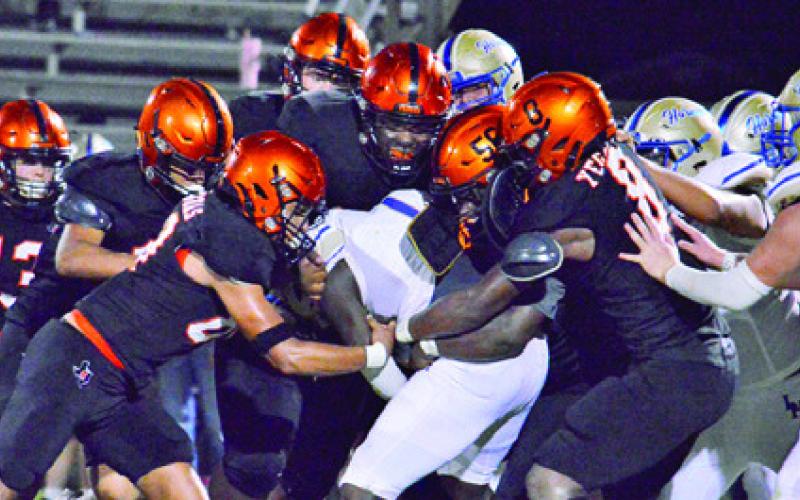 THE SOMERVILLE DEFENSE gang tackles this Louise running back last Friday in Somerville. -- Tribune photo by Roy Sanders