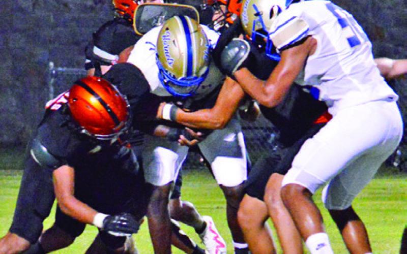 THE SOMERVILLE YEGUAS defense surrounds this Louise ball carrier last Friday in Somerville. -- Tribune photo by Roy Sanders