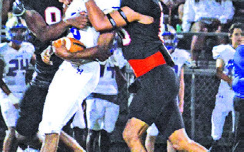 KEKE DANIELS and Victor Orozco make a tackle against Louise last Friday.