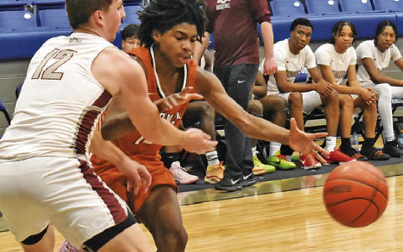 JADEN HAGAN MOVES the ball against A&amp;amp;M Consolidated JV at the Mumford Tournament. Caldwell lost 72-42. Tribune photo by Roy Sanders