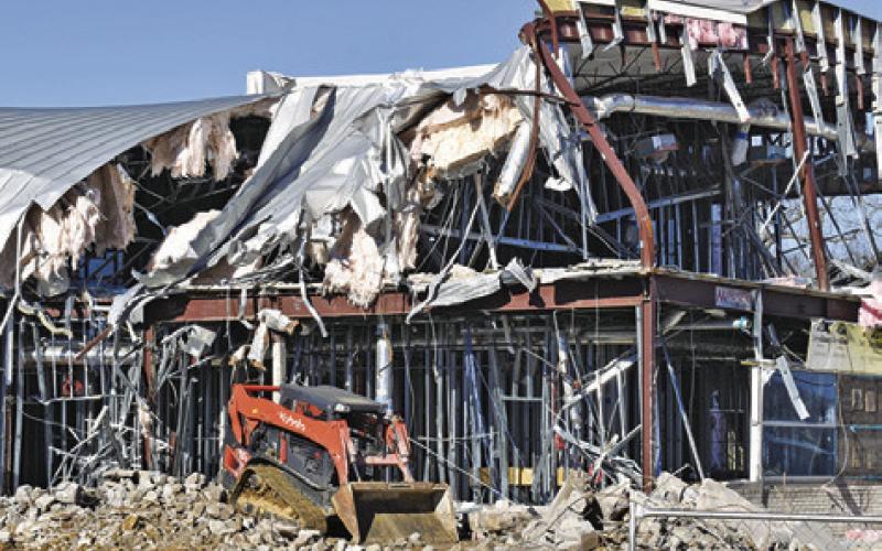 THE DEMOLITION OF this side of the city hall construction site is visable by motorists passing by. The demolition began last week.
