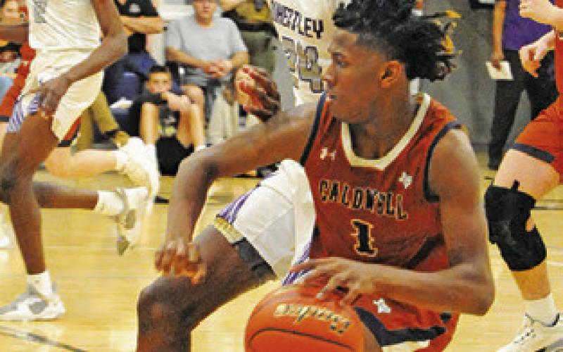 JIMMY KEARNEY OF Caldwell dribbles around this defender in the Wheatley game.