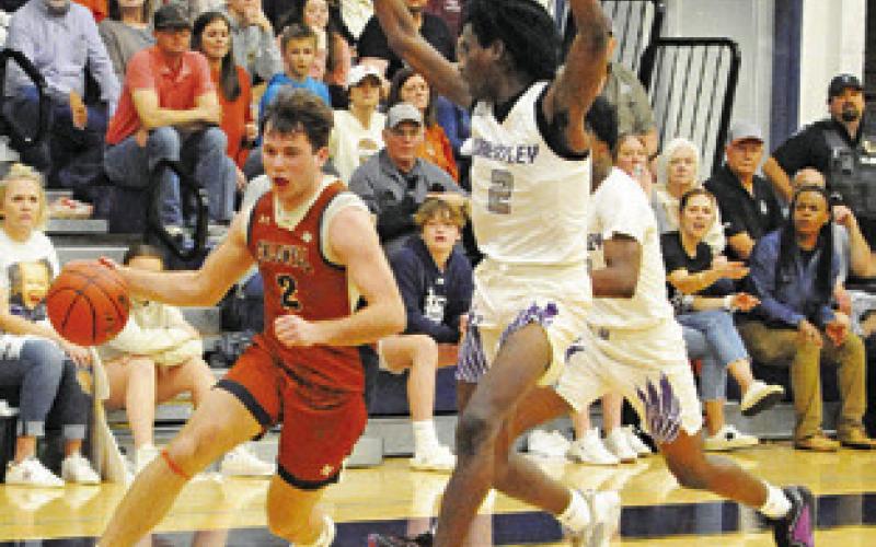 CALDWELL’S JAMIN WHITE dribbles the ball past these Wheatley defenders in the playoff game. -- Tribune photo by Denise Squier