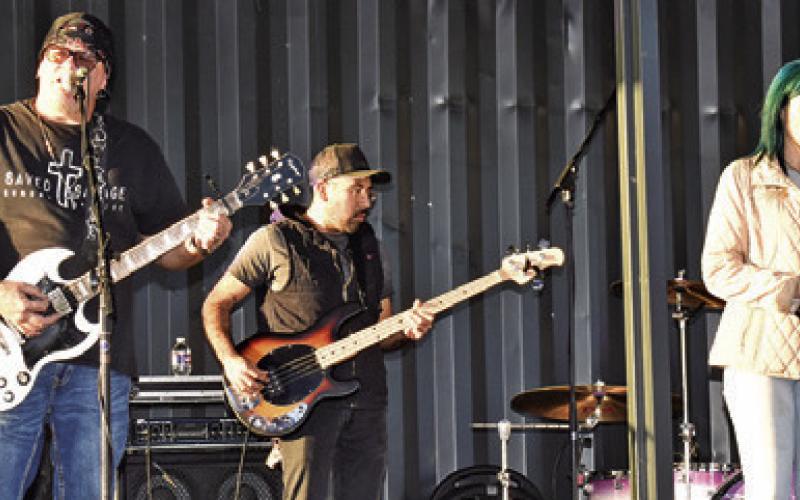 LOCAL CHRISTIAN BAND “Forged in Faith” perform at the “Christmas at Welch Park Music Festival” in Somerville on Saturday. Pictured, from left, are Matt Kelly, Isreal Gaytan and Samantha Faust. Tribune photo by Roy Sanders