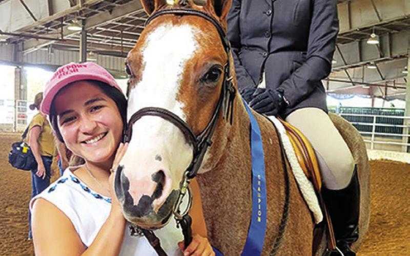 LAZO AND KASEY HERZOG OF College Station are shown with Herzog’s horse, Anita Luvah, after the pair won their first world championship title. Photo courtesy of Lazo Performance Horses