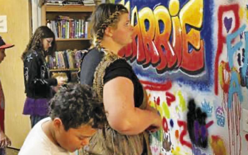 TEENAGE READERS AT THE Harrie P. Woodson Memorial Library showcased their art skills on the library’s “Graffiti Wall.”