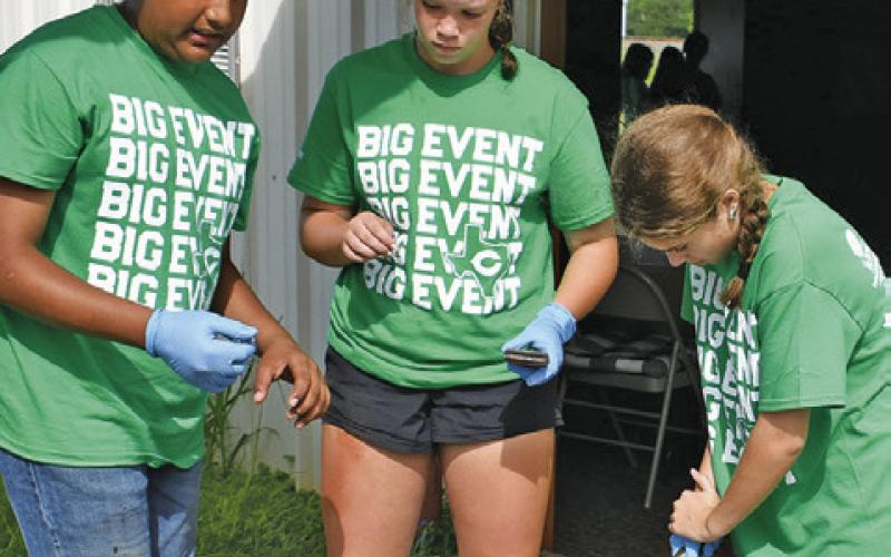 CALDWELL JUNIOR HIGH students work on repairing this door at the Chriesman Community Center on Friday, May 15, during the students’ annual Big Event service project.