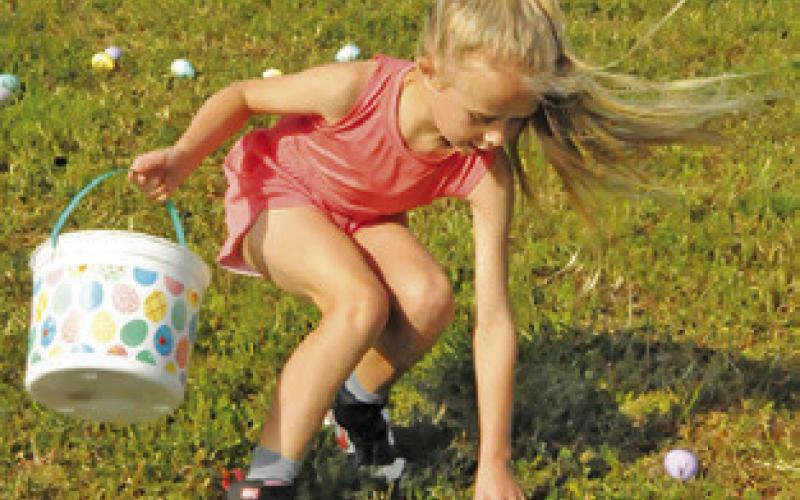 THIS CHILD REACHES for another Easter egg during First Baptist Church of Caldwell’s Easter Egg Hunt on Saturday.