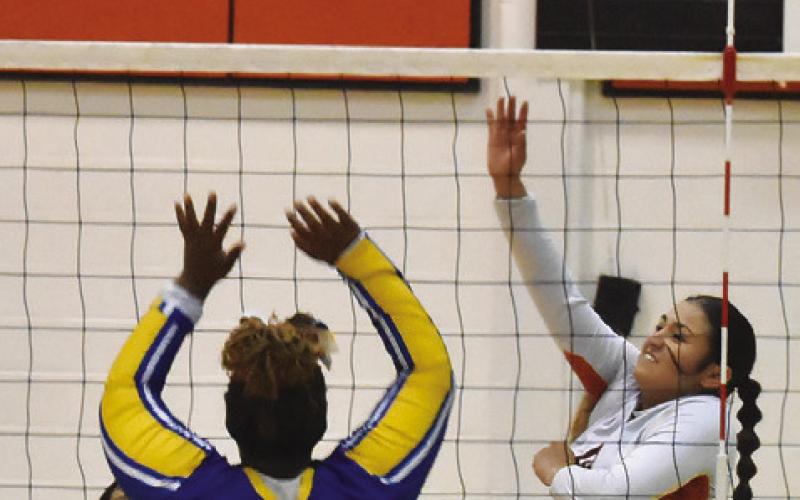 SOMERVILLE’S VIVIANNA MUNOZ hits the ball over a Dime Box blocker during the Lady Yeguas’ win last Friday. Tribune photo by Roy Sanders