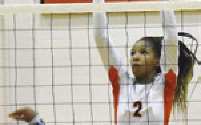 KARYS ELLIS GOES up to block a hit from a Dime Box player during last Friday’s match. Tribune photo by Roy Sanders