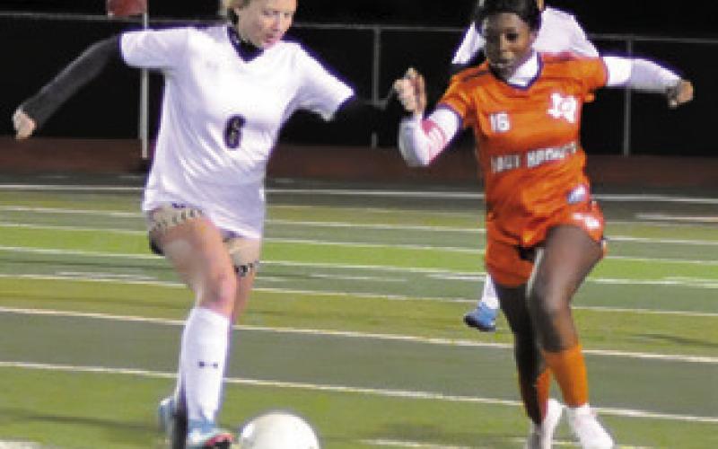 AMOREE DENSON prepares to challenge Giddings’ Allyson Dowell for possession of the ball during the Caldwell-Giddings game last Friday. Tribune photo by Denise Squier