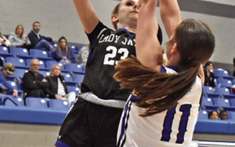 DAKOTA KEINOW of Snook shoots as this Mumford player defends. Snook lost 52-25.