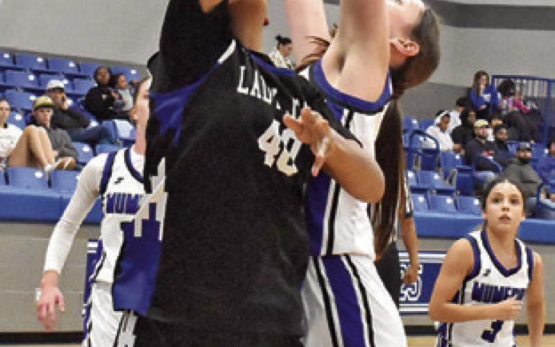 TEYANA NICKERSON shoots against Mumford last Friday in Mumford. Tribune photo by Roy Sanders
