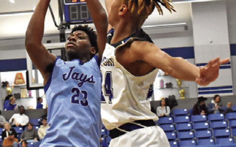 KE’TREEN CARTER of Snook takes a shot as this Mumford player defends. Tribune photo by Roy Sanders