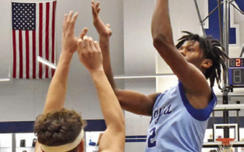JIMMY KEARNEY of Snook lunges high for this shot against Mumford last Friday. Tribune photo by Roy Sanders