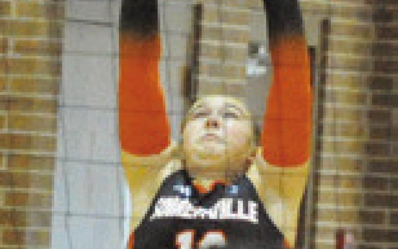 HADLEY HOWE pushes the ball over the net for a point against Hearne during the Somerville Volleyball Tournament on Saturday. Tribune photo by Denise Squier