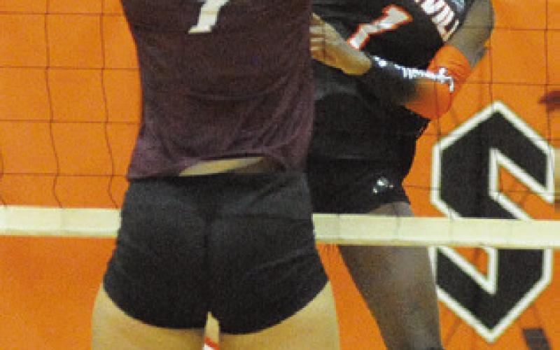 JANAYA ISOM FACES a Hearne player at the net, winning a point during the Somerville Volleyball Tournament on Saturday. Tribune photo by Denise Squier