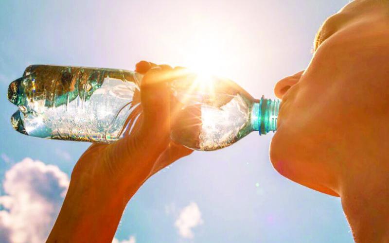 KEEPING WELL HYDRATED is one way to help avoid heat-related illnesses such as heat exhaustion or heatstroke. Adobe stock image