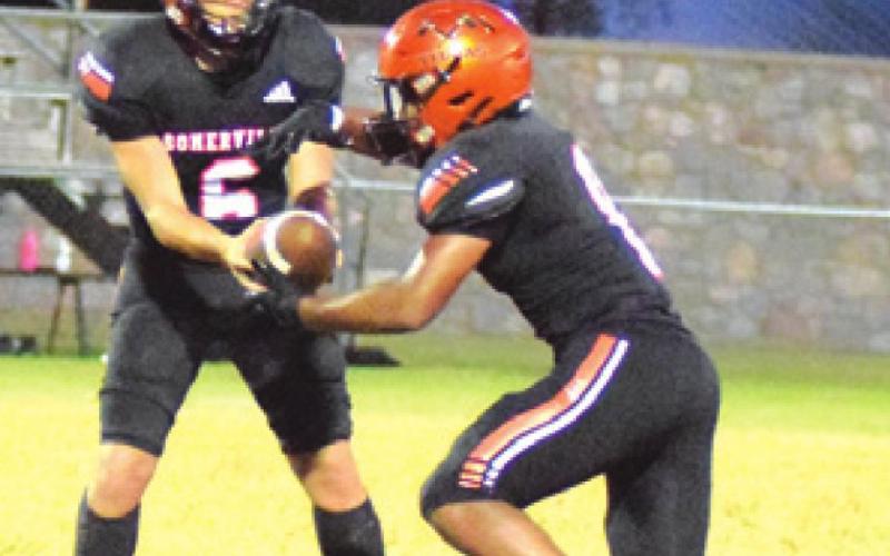 SOMERVILLE QUARTERBACK Ian Teague hands off to Deven Green during the Yeguas’ game against Alpha Omega Academy.