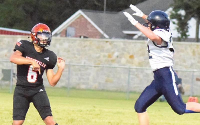 SOMERVILLE’S IAN TEAGUE gets the ball thrown as an Alpha Omega Academy player puts pressure on him. -- Tribune by Denise Squier