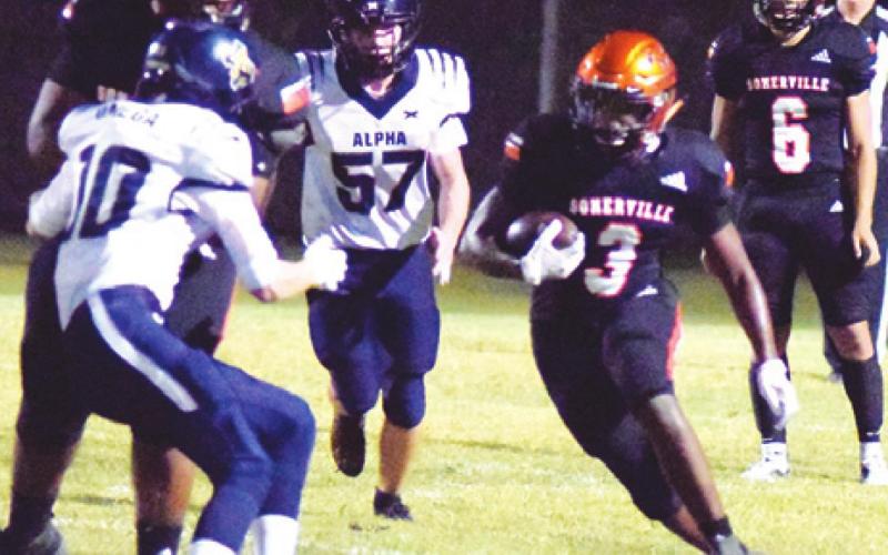 SOMERVILLE’S ARVIS BURNS runs through a hole in the front line during the Somerville-Alpha Omega Academy game last Friday night in Somerville. -- Tribune photo by Denise Squier