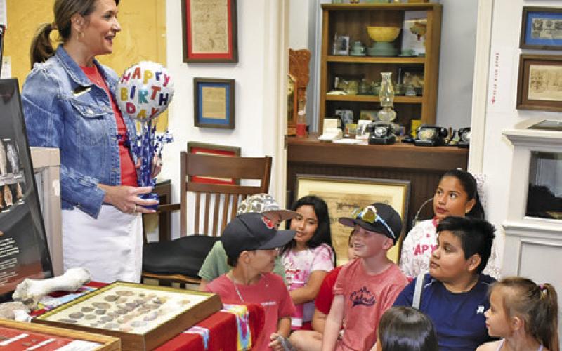 AMY JURICA TALKS to these Caldwell students during a Burleson County Heritage Week presentation at the county museum last Friday. Burleson County celebrated its 180th birthday last week. Tribune photo by Roy Sanders