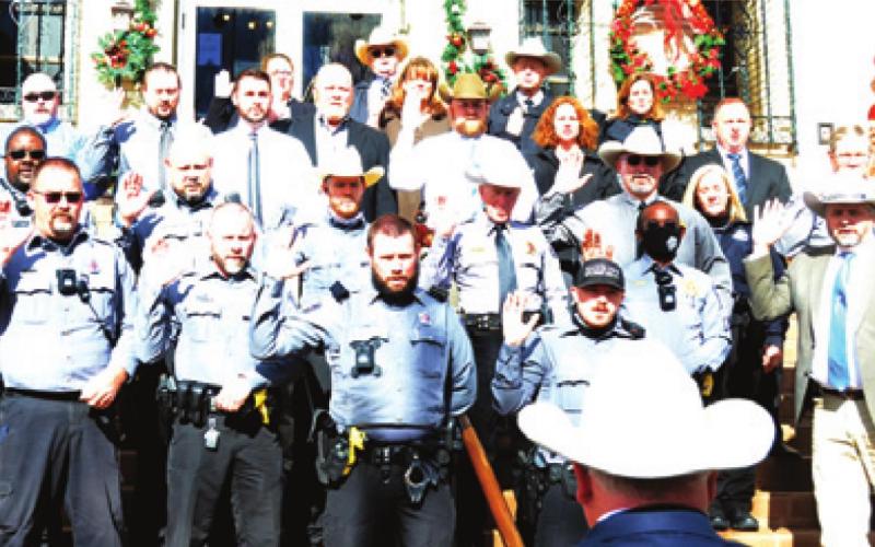 BURLESON COUNTY SHERIFF Gene Hermes swears into office his deputies and reserve deputies on the county courthouse steps.