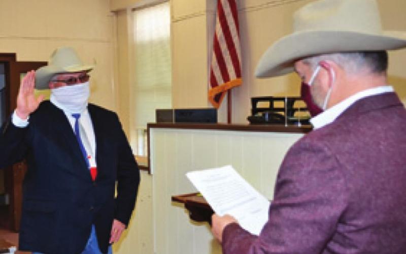 BURLESON COUNTY SHERIFF Gene Hermes is sworn into office by County Judge Keith Schroeder. -- Tribune photo by Roy Sanders