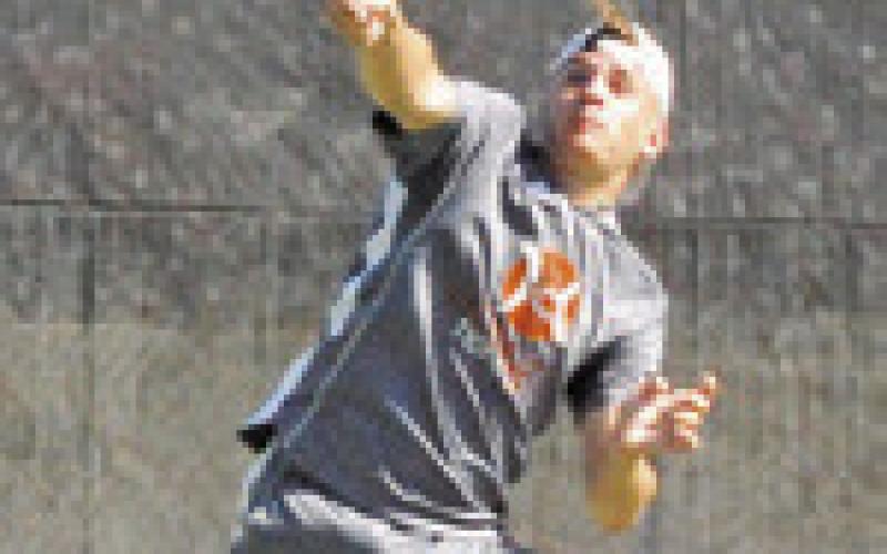 WAYLON CHAPMAN returns a volley during his and teammate Connor Hughson’s boys doubles semifinal match. -- Tribune photo by Denise Squier