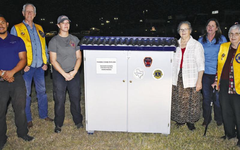 THE FOOD PANTRY IS placed at the Snook Volunteer Fire Department. Pictured are, from left, Burleson County SRO Officer Steven Guerrero, Steve Tunnell of the Lions Club, Beth Collins of Snook Volunteer Fire Department, Ann Sebesta of Snook EEA, Cindy Jarrott of Snook EEA and Lydia Faust of Snook EEA and the Lions Club.