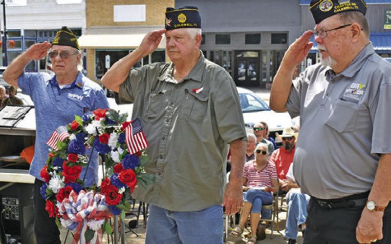 THE MEMORIAL DAY Wreath is placed on Monday at Memorial Day. Pictured from left are Henry Probst, Donny Wood and John Mayson.