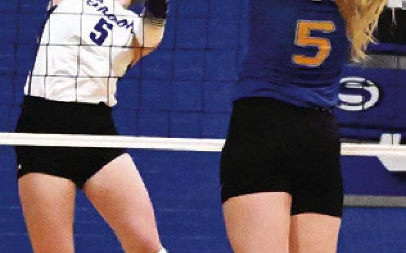 KILEY PRICE HITS the ball around the outstretched arms of a Dime Box player on Friday during Snook’s win over Dime Box. Tribune photo by Denise Squier
