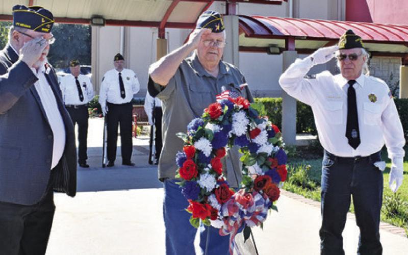 VETERANS SALUTE AS the wreath is placed at the Veterans Memorial at the Caldwell Civic Center. They include, from left, John Mayson, DAV, Donny Wood, American Legion, and Henry Probst, VFW.