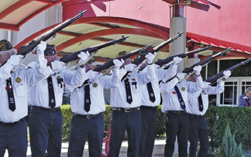 THE CALDWELL VFW Rifle Honor Guard fires its salute during the Veterans Day ceremony at the Caldwell Civic Center. Tribune photo by Roy Sanders